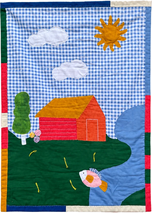 Quilt with an orange house in a green garden beneath a blue gingham sky with sun and clouds.